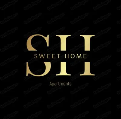 a gold sign that reads off sweet home apartments at Sweet home in Belgrade