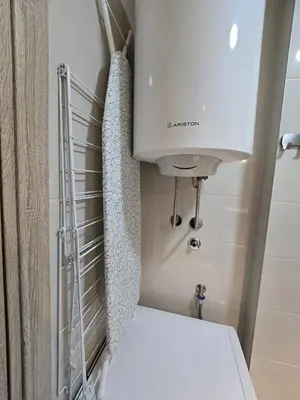 a white toilet in a bathroom with a sink at Apartman Emi in Belgrade