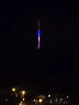 a lighted up tower in the sky at night at Apartman Emi in Belgrade