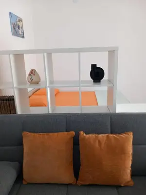 a living room with a gray couch with two pillows at Lola in Belgrade