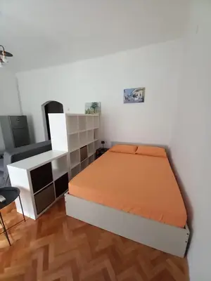 a bedroom with a bed with an orange mattress at Lola in Belgrade