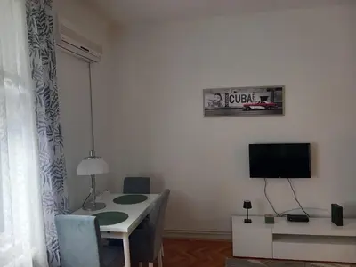 a living room with a table and a tv at Lola in Belgrade