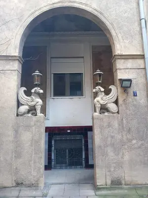 an archway with two statues of horses on a building at Lola in Belgrade
