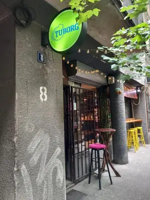 a green sign on the side of a building at Lola in Belgrade