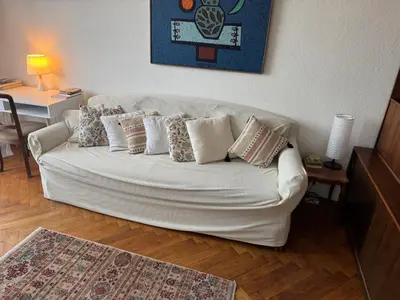 a living room with a white couch with pillows at Sweet House Retro in Belgrade