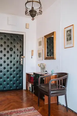 a living room with a chair and a desk at Sweet House Retro in Belgrade