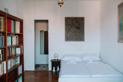 a bedroom with a bed and a book shelf at Sweet House Retro in Belgrade