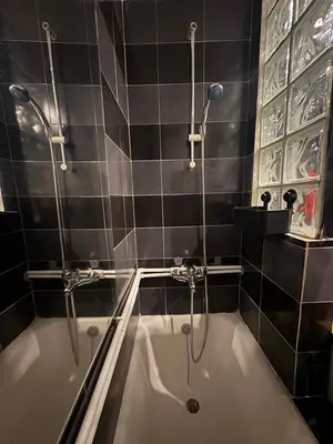 a bathroom with a bath tub and a shower at Sweet House Retro in Belgrade