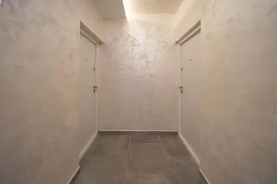 an empty hallway with two doors and a tile floor at Anja D Apartments in Belgrade