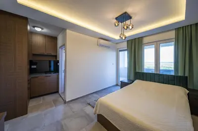 a bedroom with a bed and a large window at Anja D Apartments in Belgrade