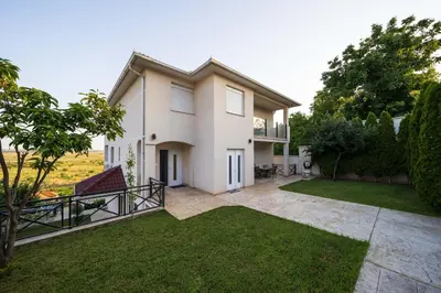 an image of a house with a yard at Anja D Apartments in Belgrade