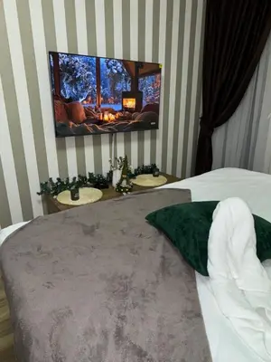 a bedroom with two sinks and a tv on the wall at Freedom APARTMAN RUMA in Ruma