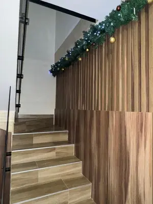 a stairway with christmas lights on the wall at Freedom APARTMAN RUMA in Ruma