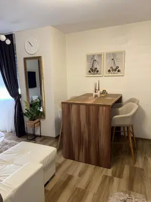 a living room with a table and a couch at Freedom APARTMAN RUMA in Ruma