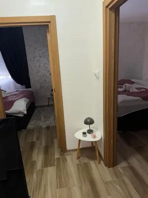 a small stool in a room with a mirror at Freedom APARTMAN RUMA in Ruma