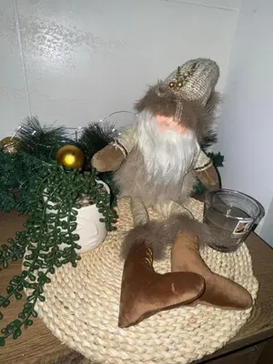 a stuffed animal sitting on top of a table with shoes at Freedom APARTMAN RUMA in Ruma