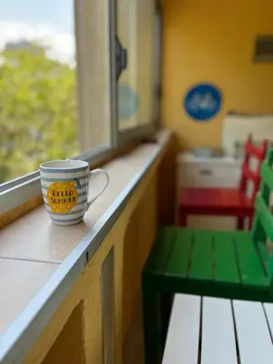 a coffee cup sitting on a counter next to a window at Orientale in Belgrade