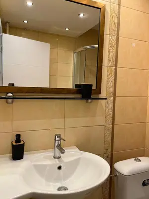 a bathroom with a sink and a mirror and a toilet at Orientale in Belgrade