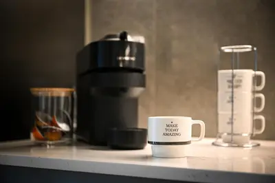 a coffee cup sitting on top of a counter at Belgrade Waterfront LINA Apartments in Belgrade