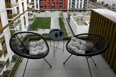 two chairs and a table on a balcony at Belgrade Waterfront LINA Apartments in Belgrade