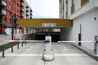 a parking lot with barriers in front of a tunnel at Belgrade Waterfront LINA Apartments in Belgrade