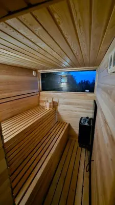 a small wooden sauna with a television in it at Beška Sauna View in Beška