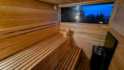 a sauna with a bench and a window at Beška Sauna View in Beška