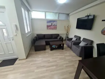 a living room with a couch and a tv at Fantastic Belgrade Nights II in Belgrade