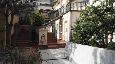 a building with stairs and plants in front of it at Fantastic Belgrade Nights II in Belgrade
