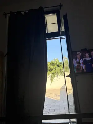 an open door with two children looking out of it at Amar1 in Belgrade