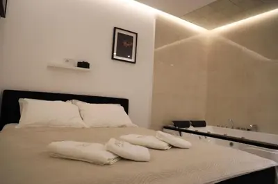 a bedroom with a bed with two pillows on it at Point Apartman in Belgrade