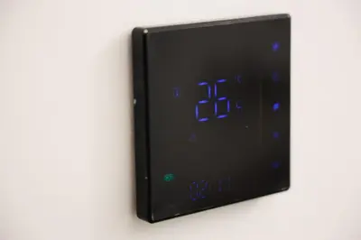 a clock on a wall with blue numbers on it at Point Apartman in Belgrade