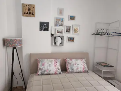 a bedroom with a bed with pillows and pictures on the wall at Studio Kalemegdan in Belgrade