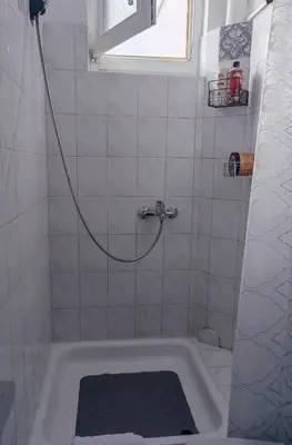 a bathroom with a bath tub with a shower at Studio Kalemegdan in Belgrade