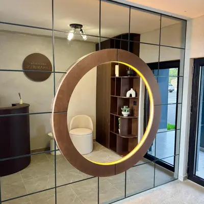 a round mirror on a wall in a room at Apartmani Tanasijević