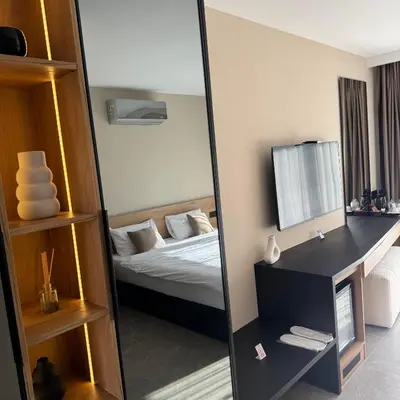 a mirror in a room with a bed and a bedroom at Apartmani Tanasijević