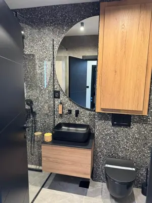 a bathroom with a sink and a mirror at Apartmani Tanasijević