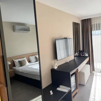 a hotel room with a bed and a mirror at Apartmani Tanasijević