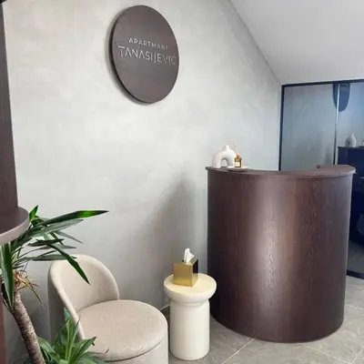 a room with a podium and a chair and a toilet at Apartmani Tanasijević