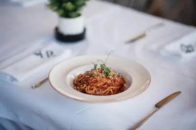 a white plate of food on a table at Hotel Heritage in Belgrade