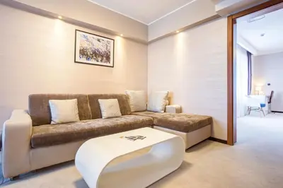 a living room with a couch and a coffee table at Hotel Heritage in Belgrade