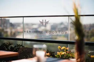 a table in a restaurant with a logo on the window at Hotel Heritage in Belgrade