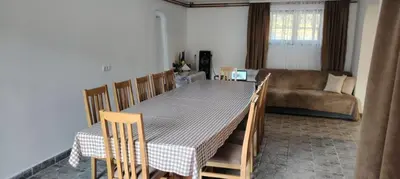 a living room with a table and chairs and a couch at Vila Terasa in Čortanovci