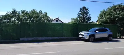 a white car parked on the side of a street at Vila Terasa in Čortanovci