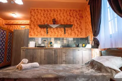 a kitchen with a large bed in a room at Etno kuća Biblioteka in Smederevo