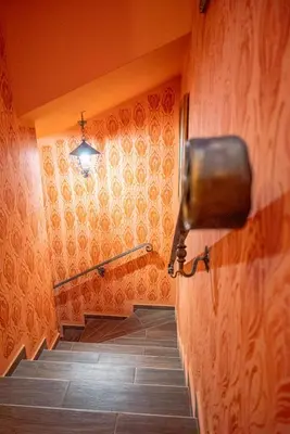 a hallway with stairs and a hand rail on a wall at Etno kuća Biblioteka in Smederevo
