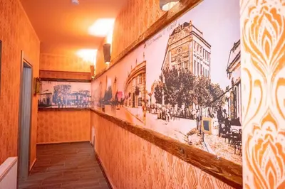 a hallway with a mural of a building on the wall at Etno kuća Biblioteka in Smederevo