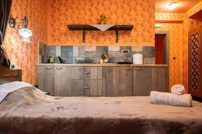 a kitchen with a large bed in a room at Etno kuća Biblioteka in Smederevo