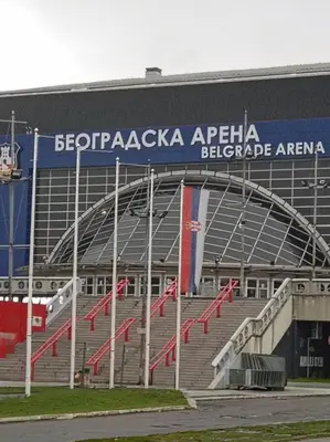a stadium with red flags in front of it at Linda Apartments- Arena in Novi Beograd
