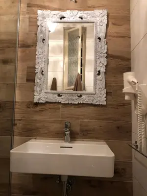 a bathroom with a white sink and a mirror at Vračar Elegance Apartment in Belgrade